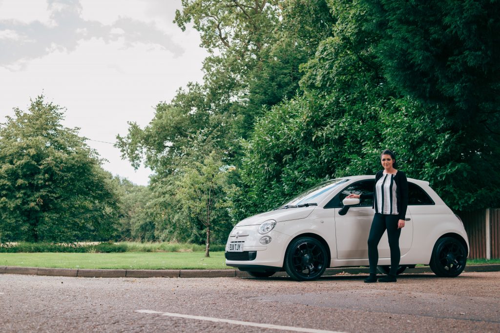 Person standing next to car