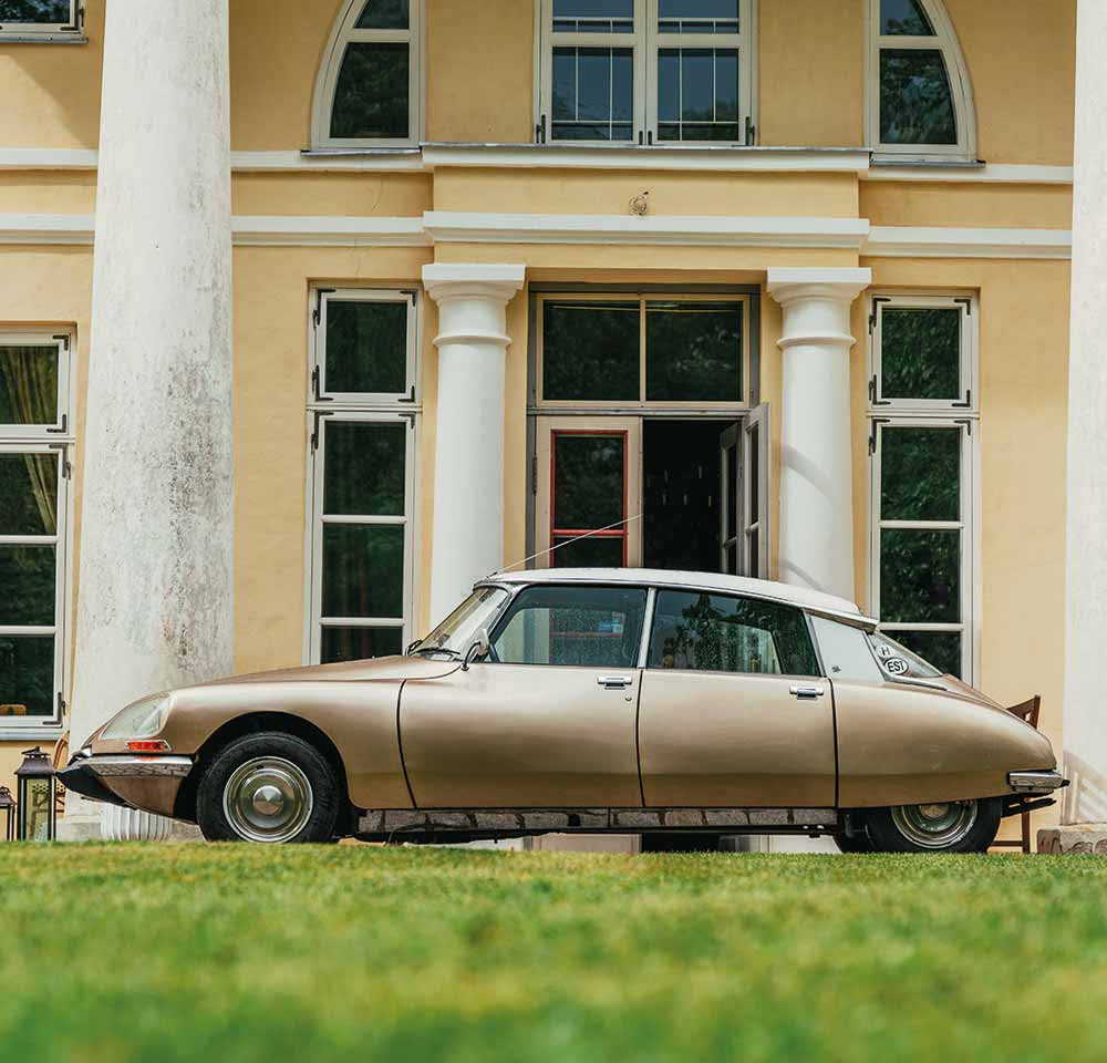 Chrome Citroen DS pictured with building in the background