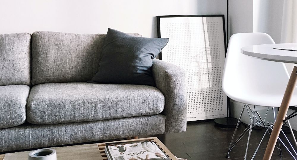 Interior of home with sofa, table and chair visible