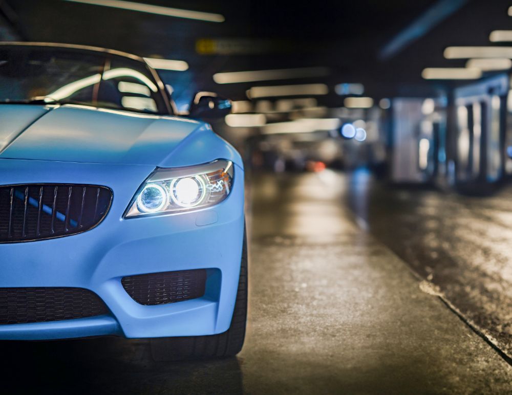 Blue BMW Z4 with headlights on