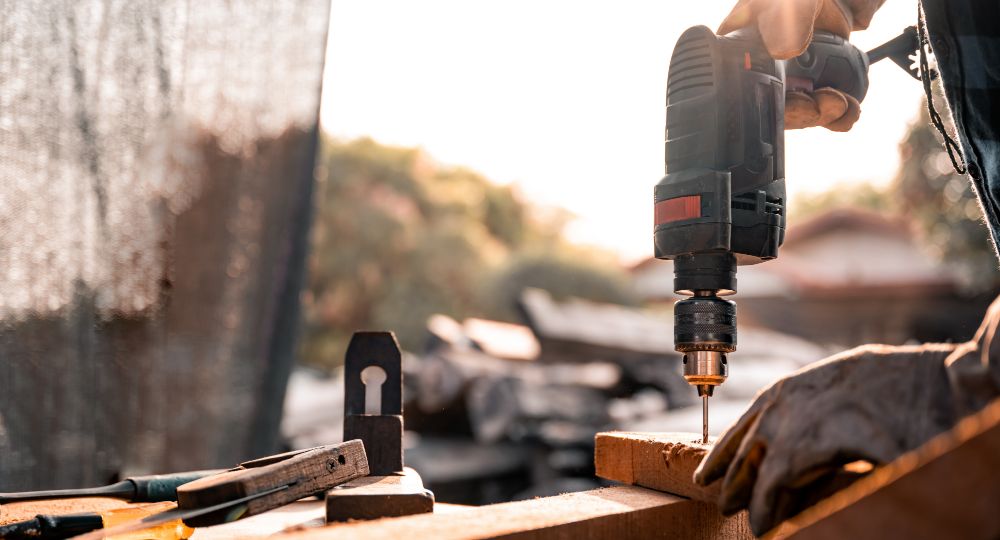 Builder drilling into wood