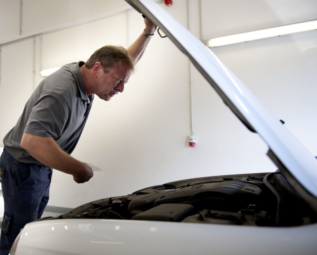 Man looking under the bonnet of a car