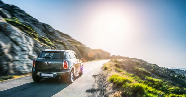 MINI car driving through mountainous area