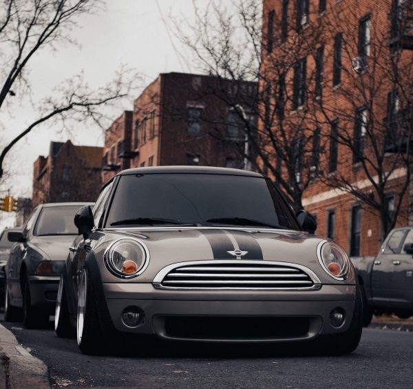 Grey Mini Cooper R56 parked outside buildings