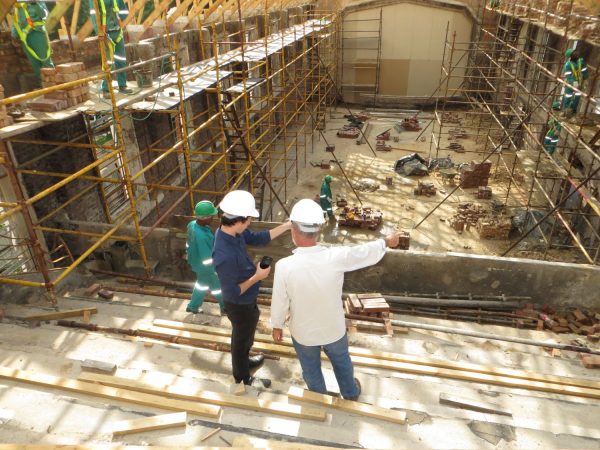 People in safety hats on a construction site