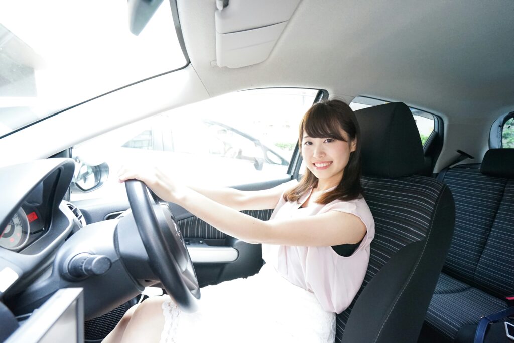 Woman driving a car, holding the steering wheel with both hands
