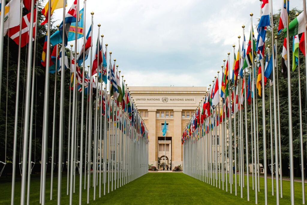 United Nations building with flags leading up to it