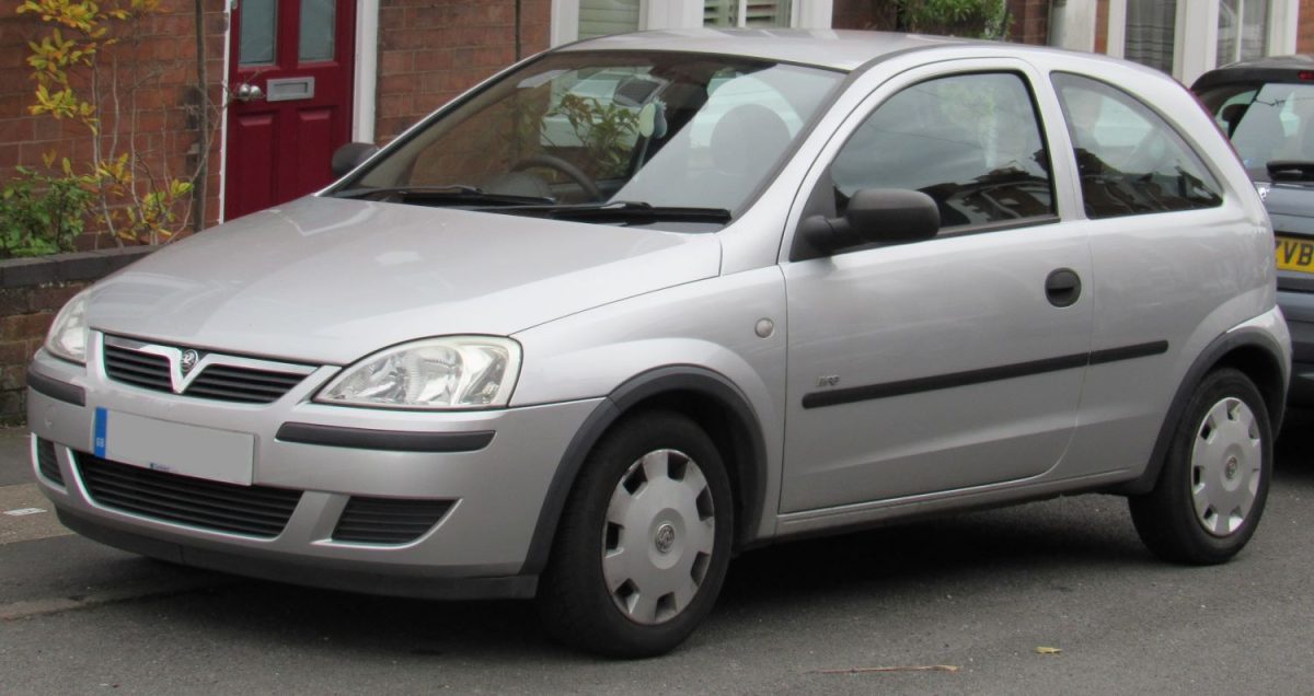 Grey Vauxhall Corsa parked outside house