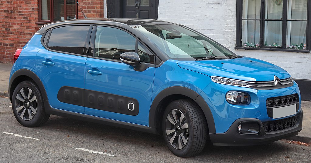 Blue Citroen C3 parked outside house